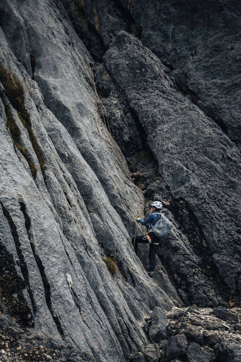Close-up of climber on vertical columnar limestone wall