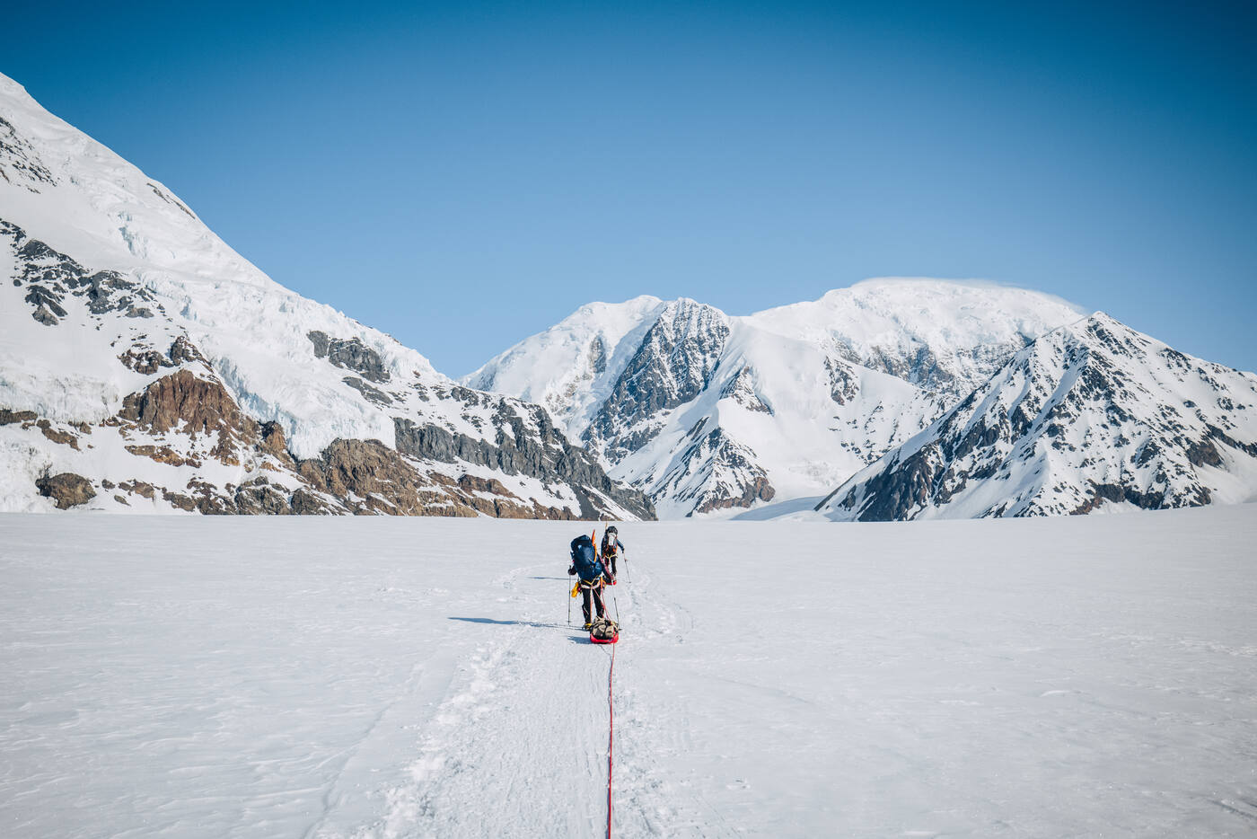 Climbers ascending the glacier on day two with bright white snow