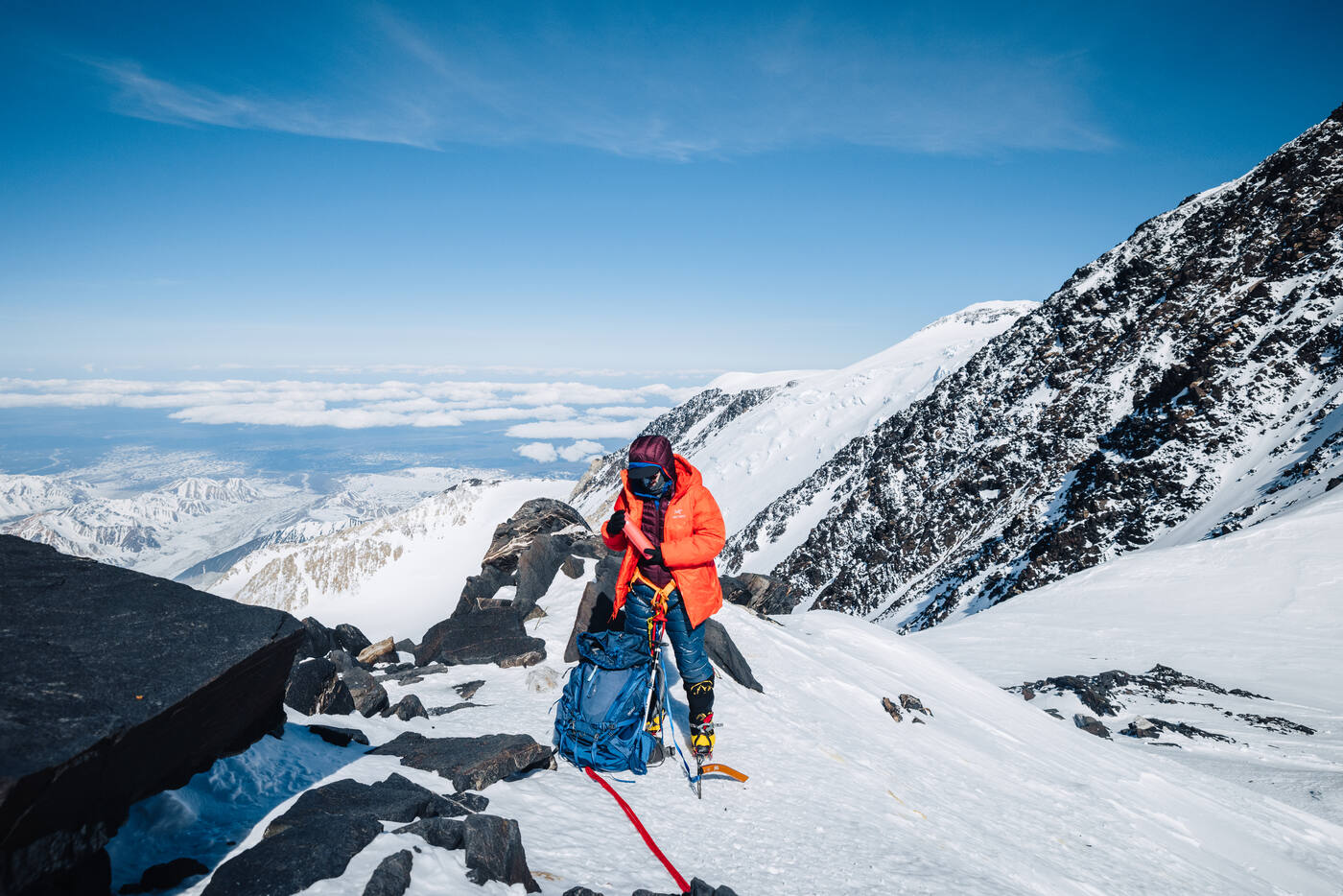 Climber ascending snowy slope during the early summit push on Denali