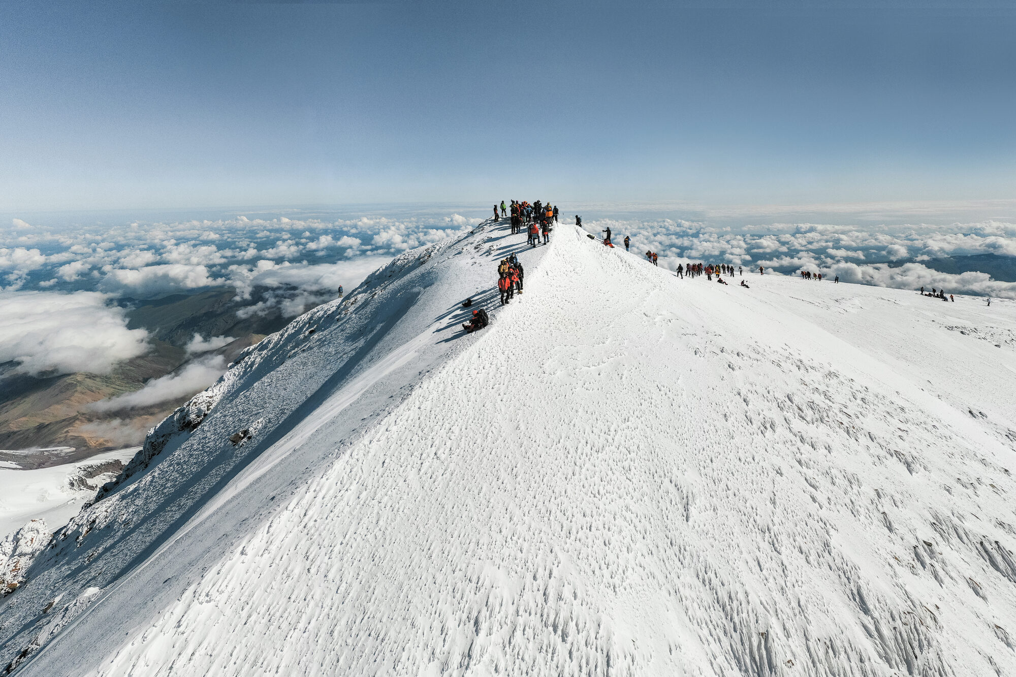 Stunning drone aerial shot of climbers on the Elbrus summit ridge