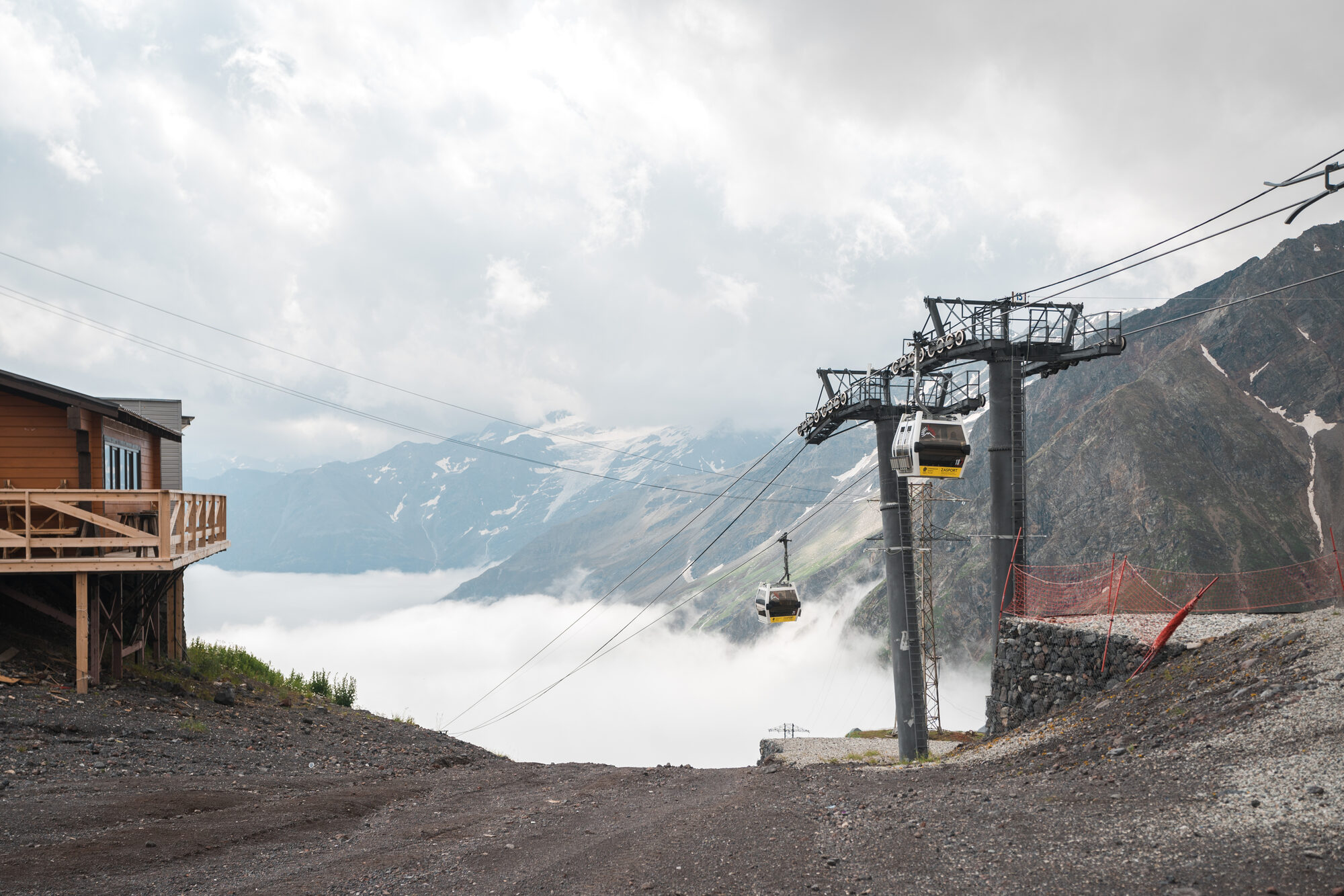 Gondola cable car station above the clouds with mountains behind on the Elbrus slopes