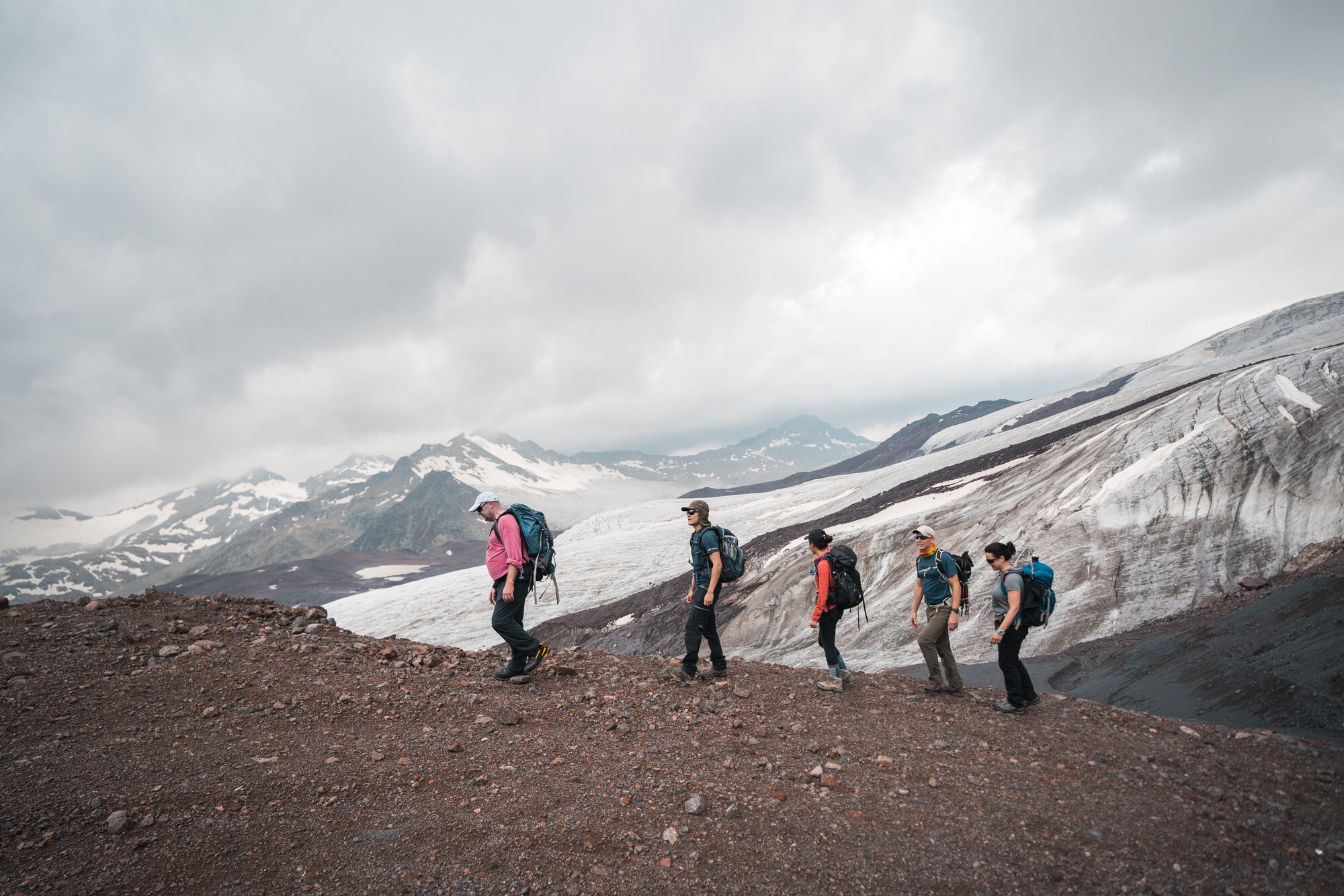Team trekking along a ridge toward Elbrus glacier