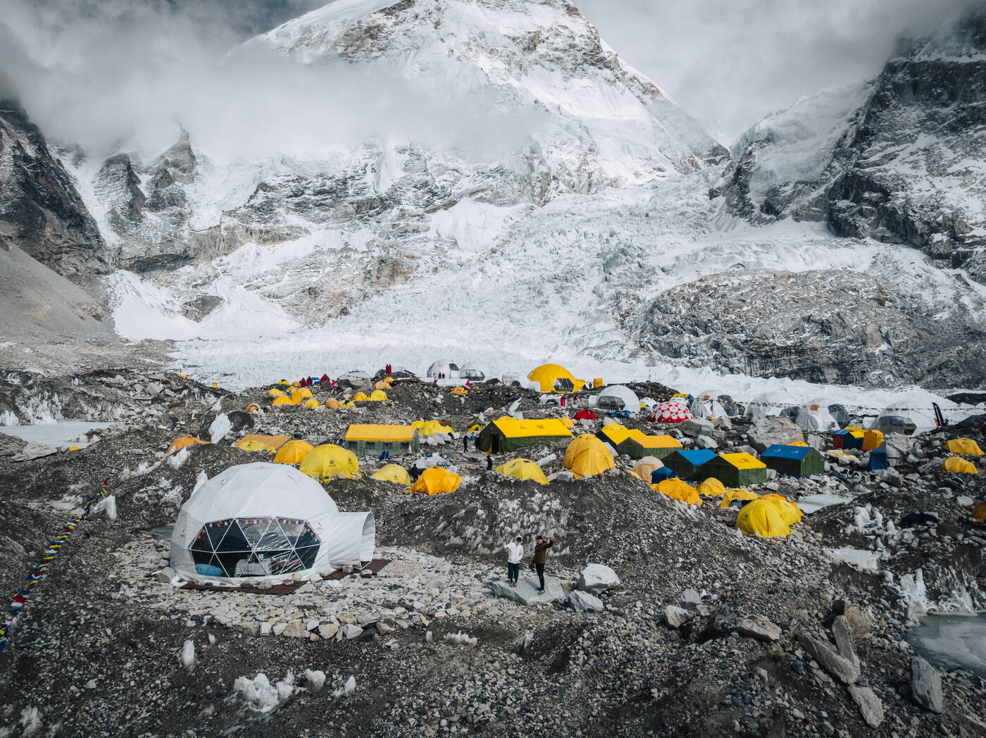 Mountain Professionals dome tent and yellow tents at Base Camp with the Khumbu Icefall behind