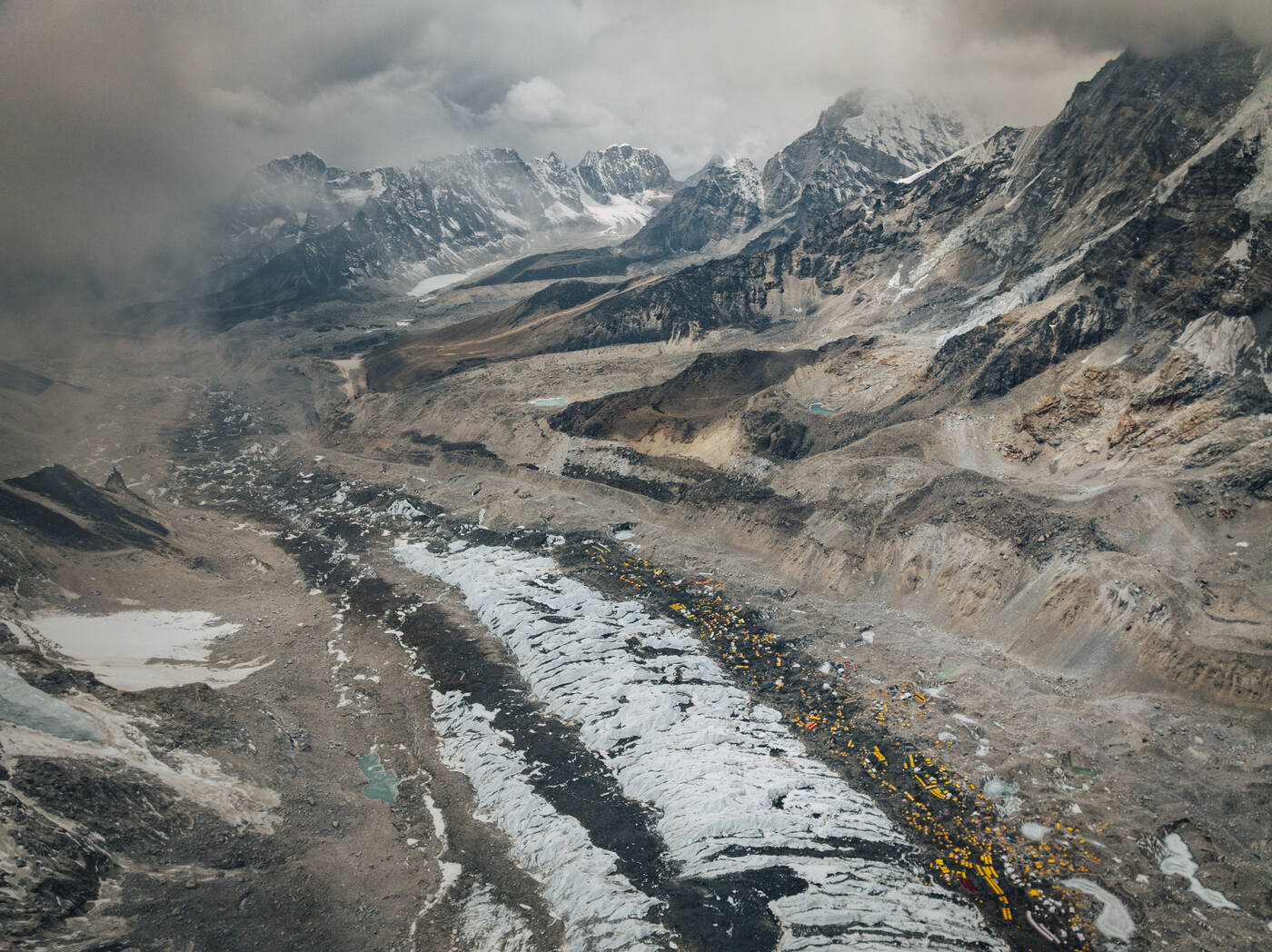 Aerial view down the Khumbu Glacier with Base Camp tents strung along the moraine