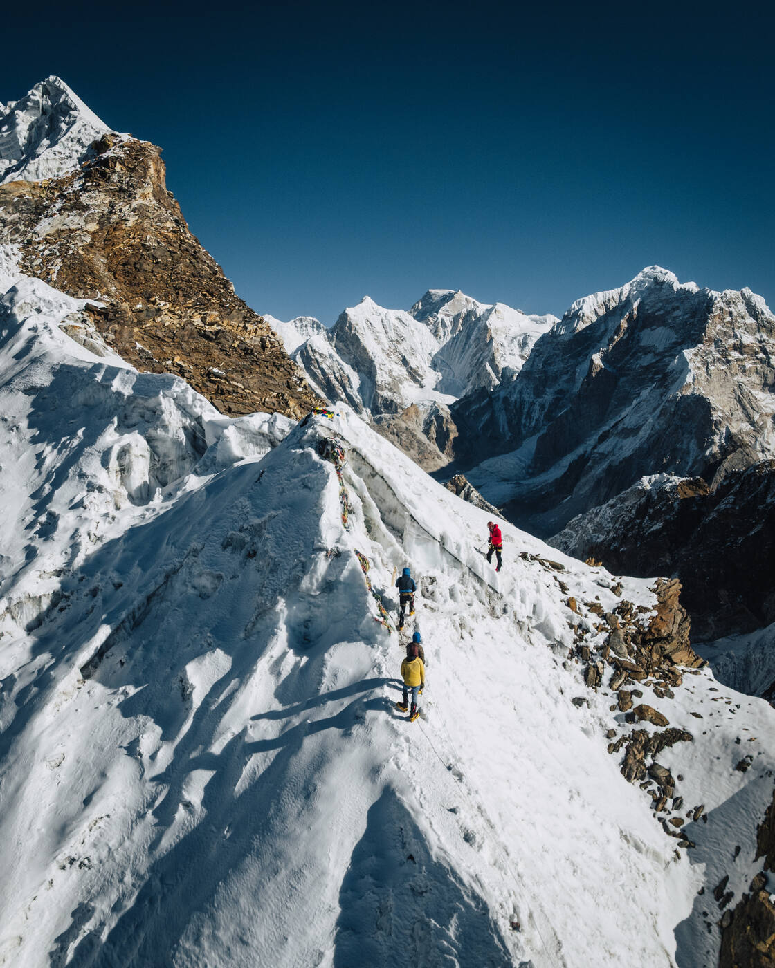 Aerial view of climbers on the snow ridge of Lobuche East with Himalayan peaks behind
