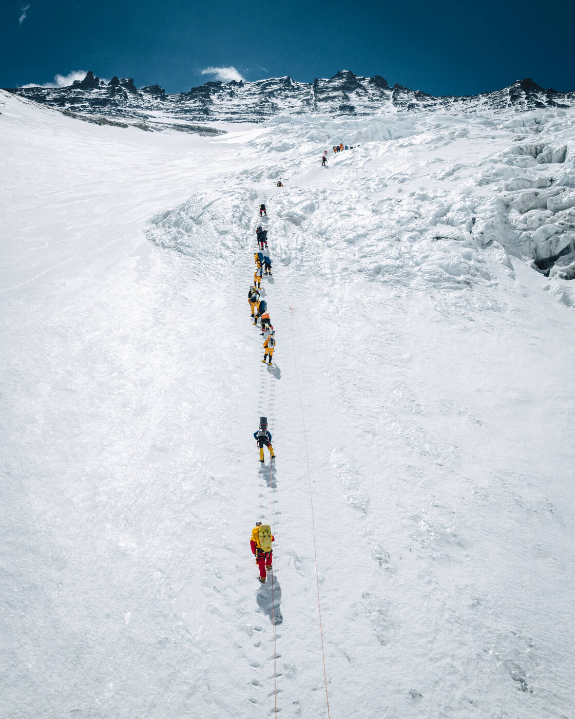 Aerial view of a line of climbers on fixed ropes ascending the Lhotse Face
