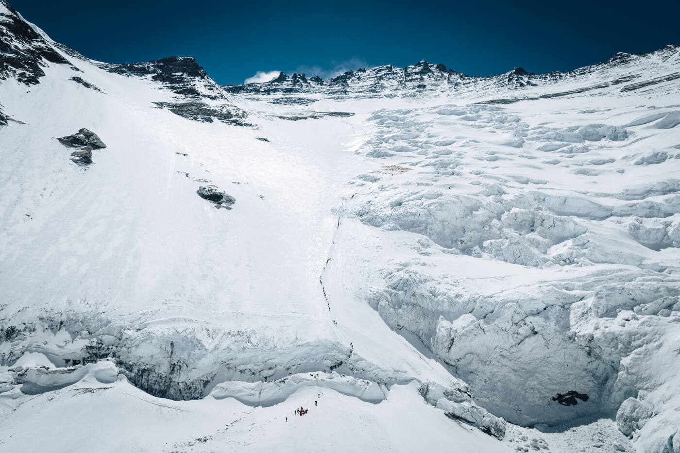 The base of the Lhotse Face with its bergschrund and climbers approaching from the upper Cwm