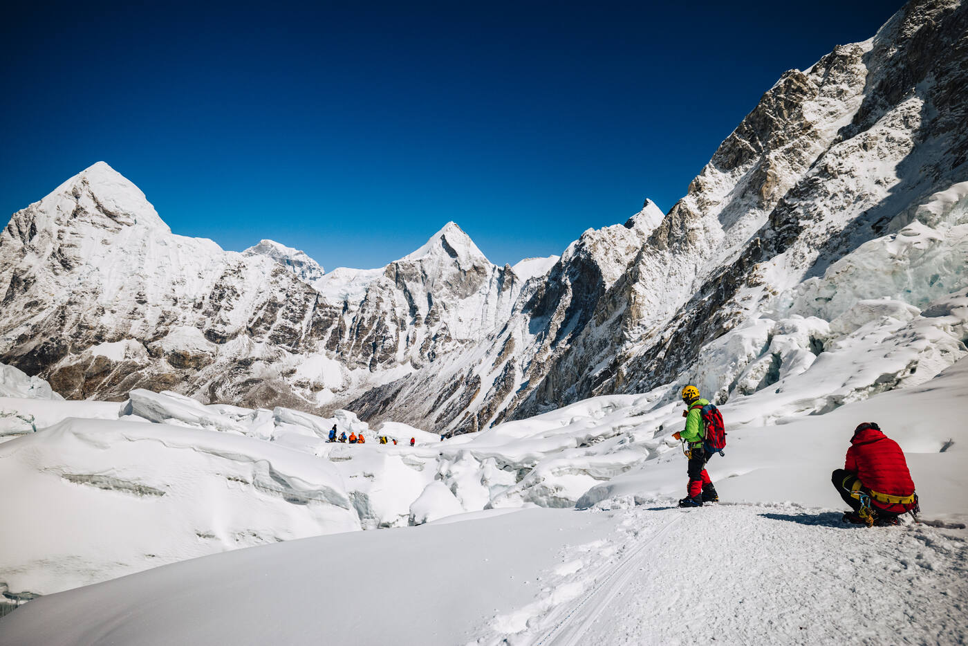 Climbers near the top of the Icefall with sharp snow peaks behind