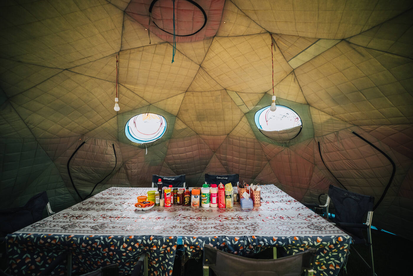 Interior of the heated dining tent at Base Camp with table set for meals and condiments
