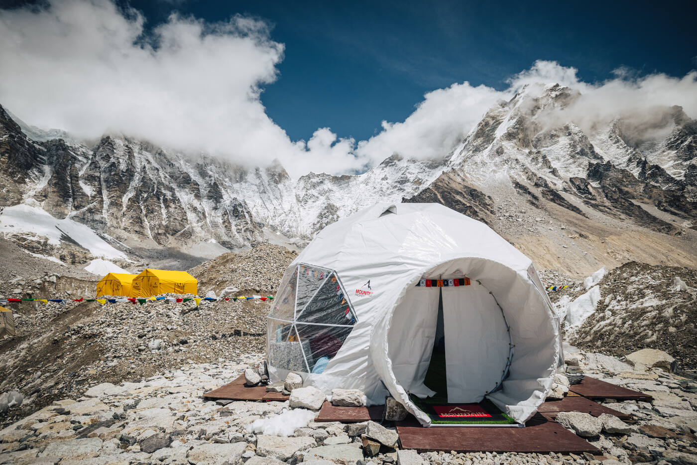 Exterior view of the Mountain Professionals dome tent at Everest Base Camp with Himalayan peaks behind
