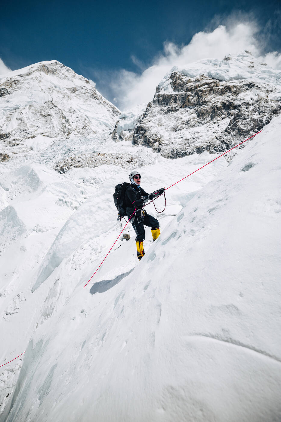 Climber ascending steep ice on fixed rope in the Khumbu Icefall near Everest Base Camp