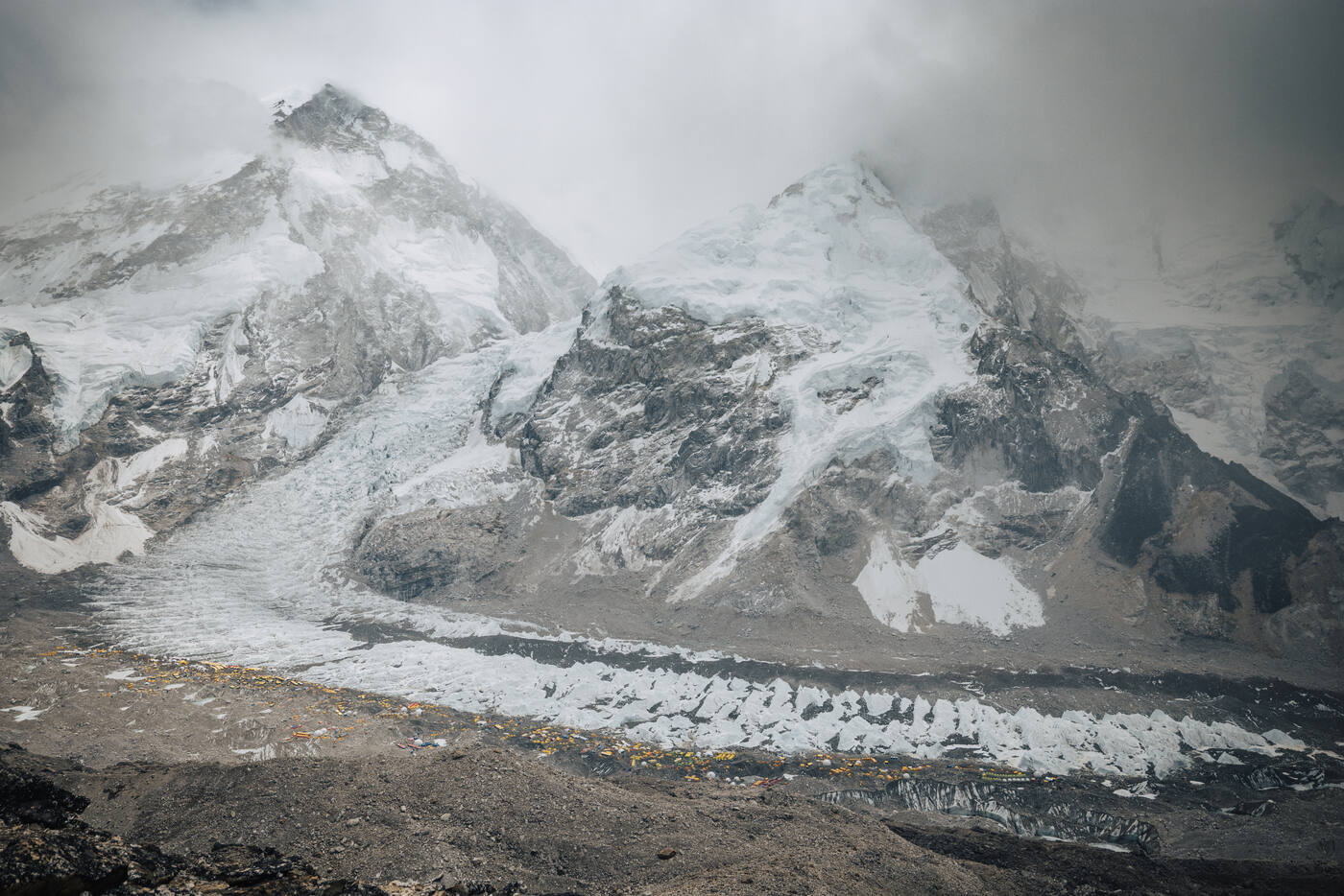 Distant view of the Khumbu Icefall and Everest massif through clouds from Base Camp