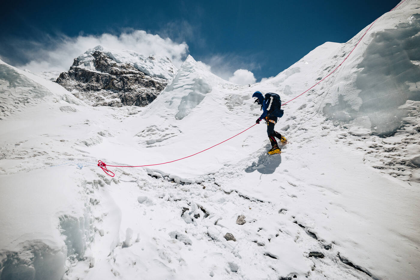 Climber navigating steep ice on fixed rope near the Khumbu Icefall entrance