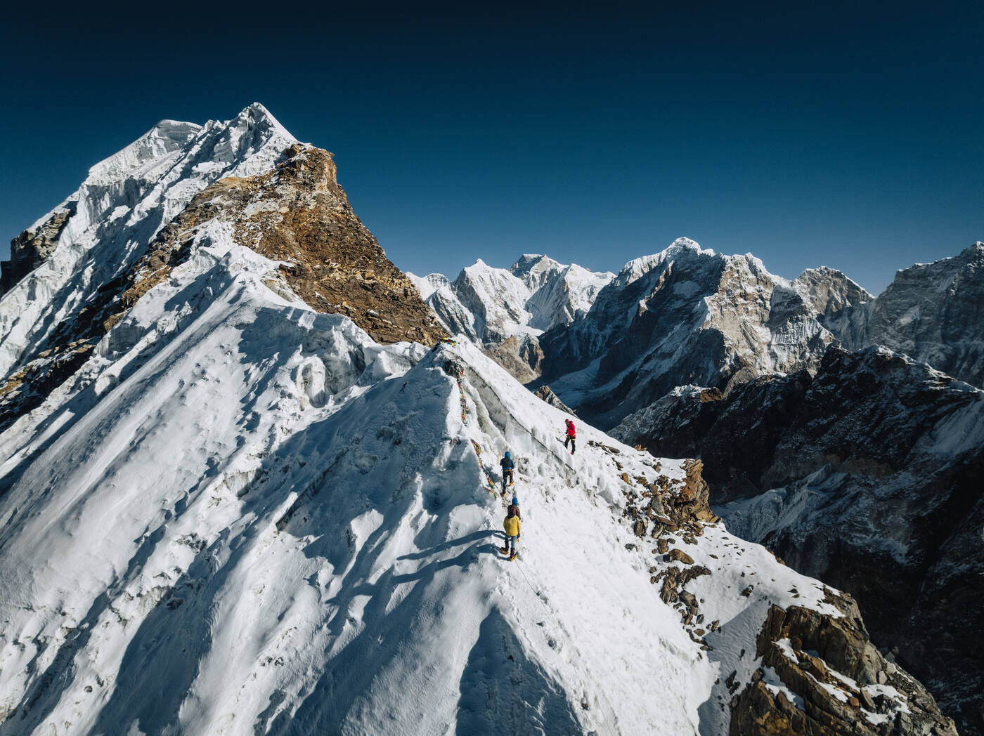 Aerial view of climbers on the knife-edge snow ridge of Lobuche East