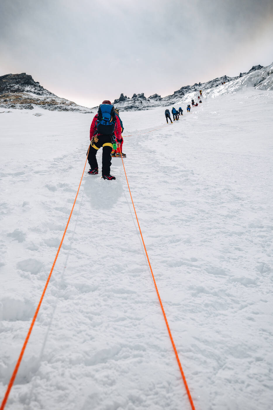 Roped climbers walking up the snow of the Western Cwm