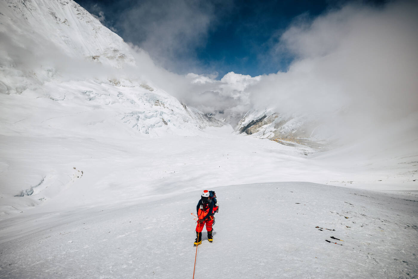 A single climber walking up the upper Western Cwm toward Camp 2