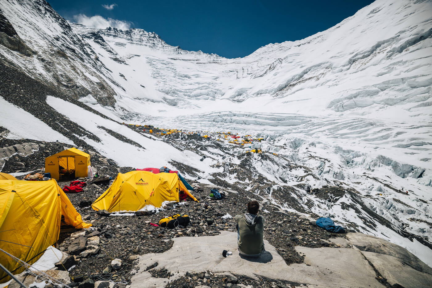 Yellow tents on the rocky moraine of Camp 2 with the Western Cwm behind