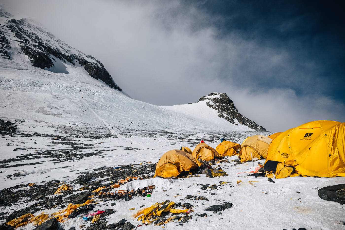 Yellow tents at a high camp on the South Col with ice face and mountain behind