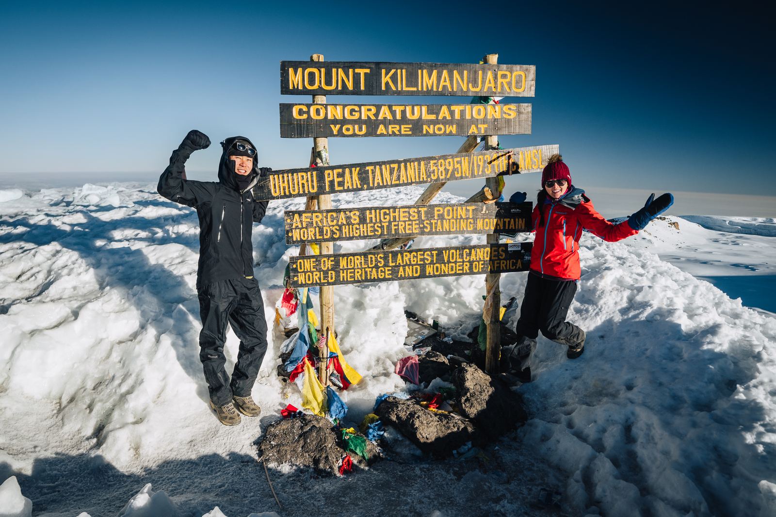 Jason and Grace together at the Uhuru Peak summit sign on Mount Kilimanjaro