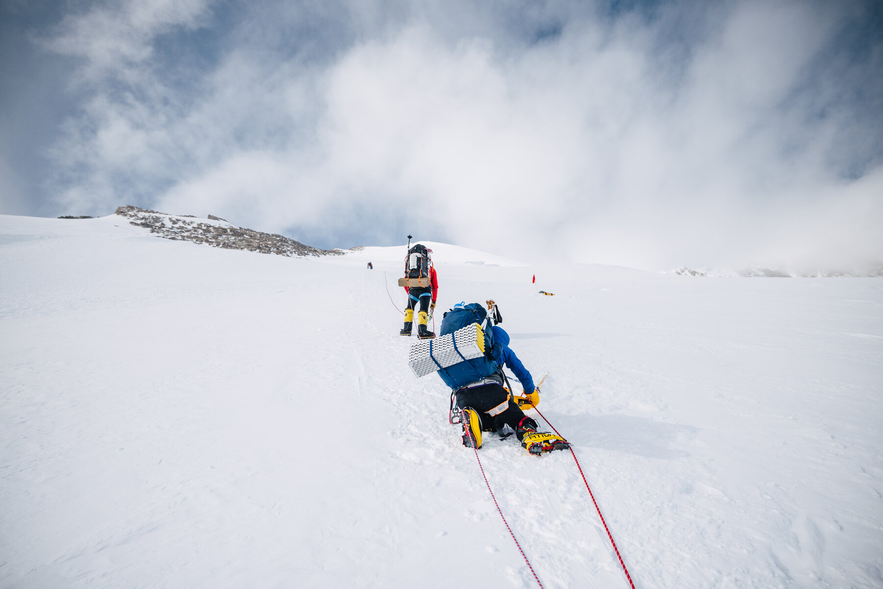 Climber using ascender on fixed rope during steep ascent of Vinson