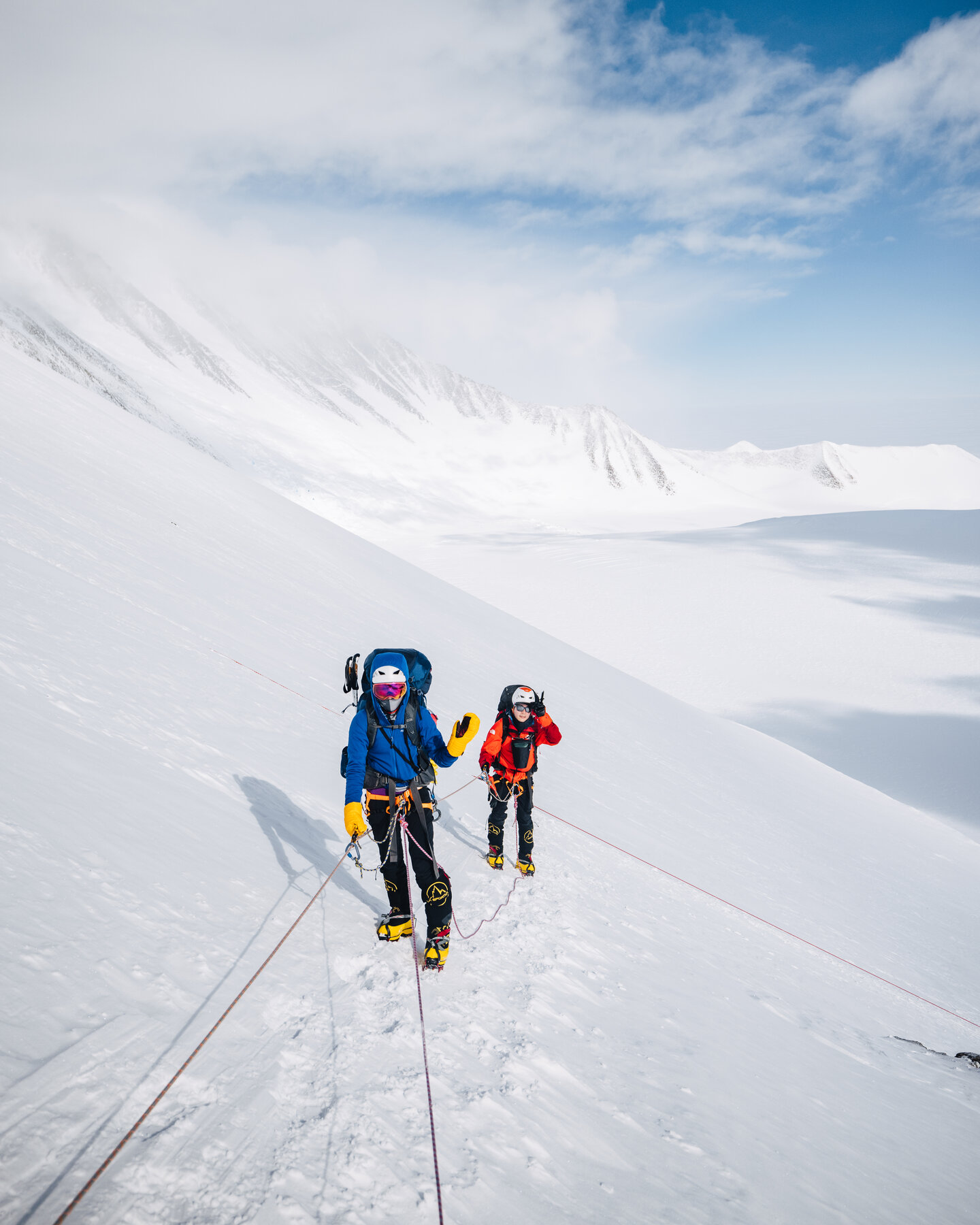 Multiple climbers on fixed ropes ascending the west face in single file