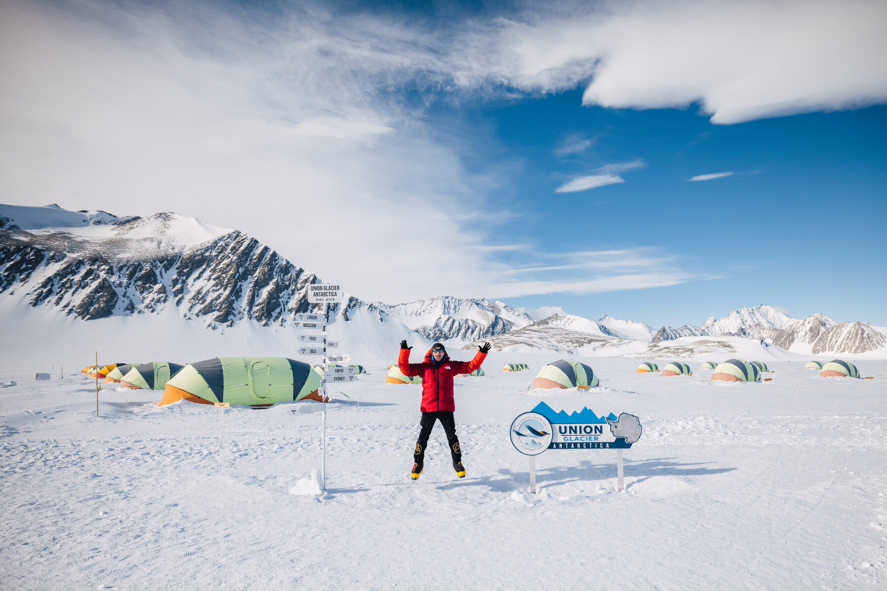 Jason at Union Glacier Camp in full expedition gear with Antarctic landscape behind