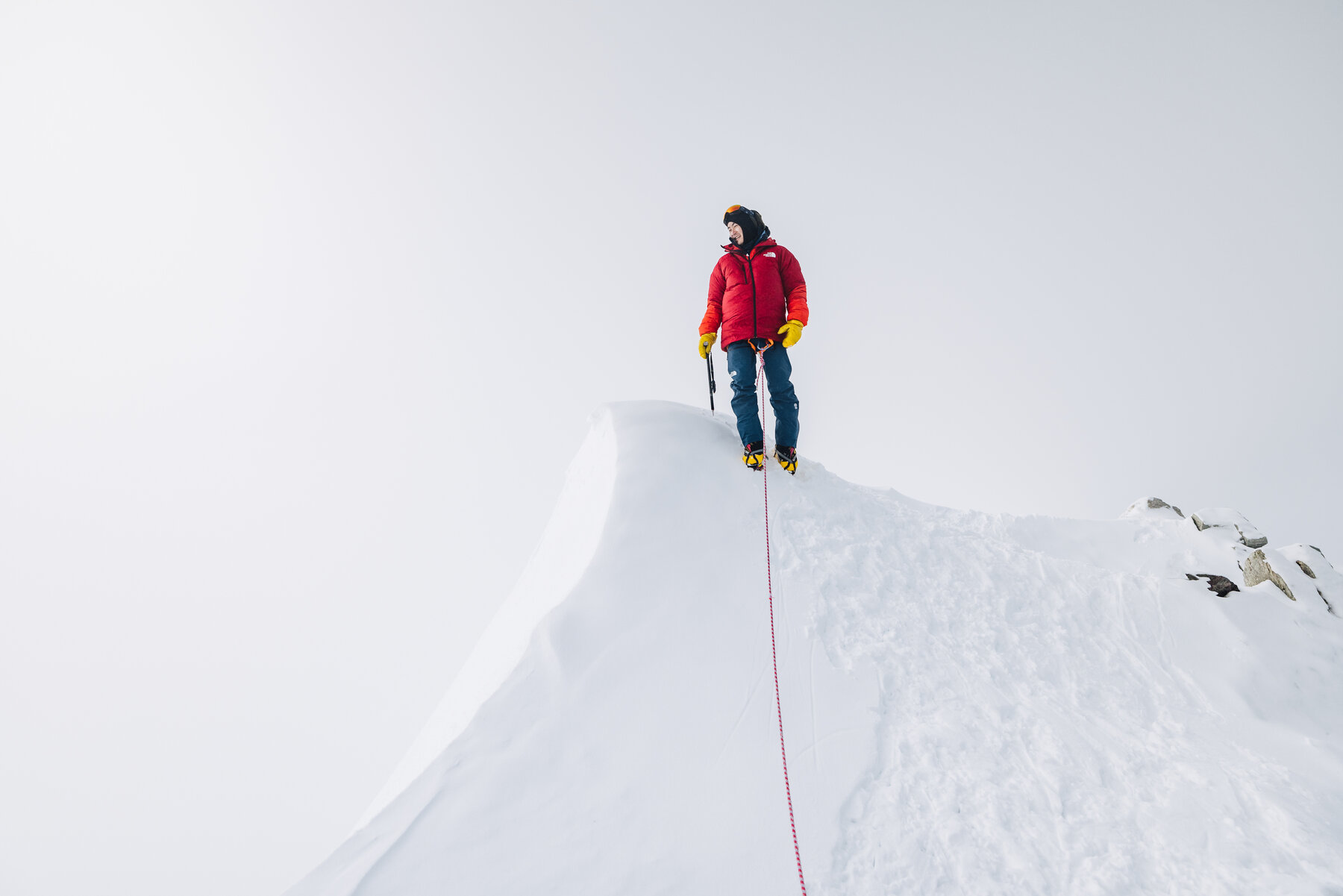 Solo climber posing at the summit of Vinson Massif