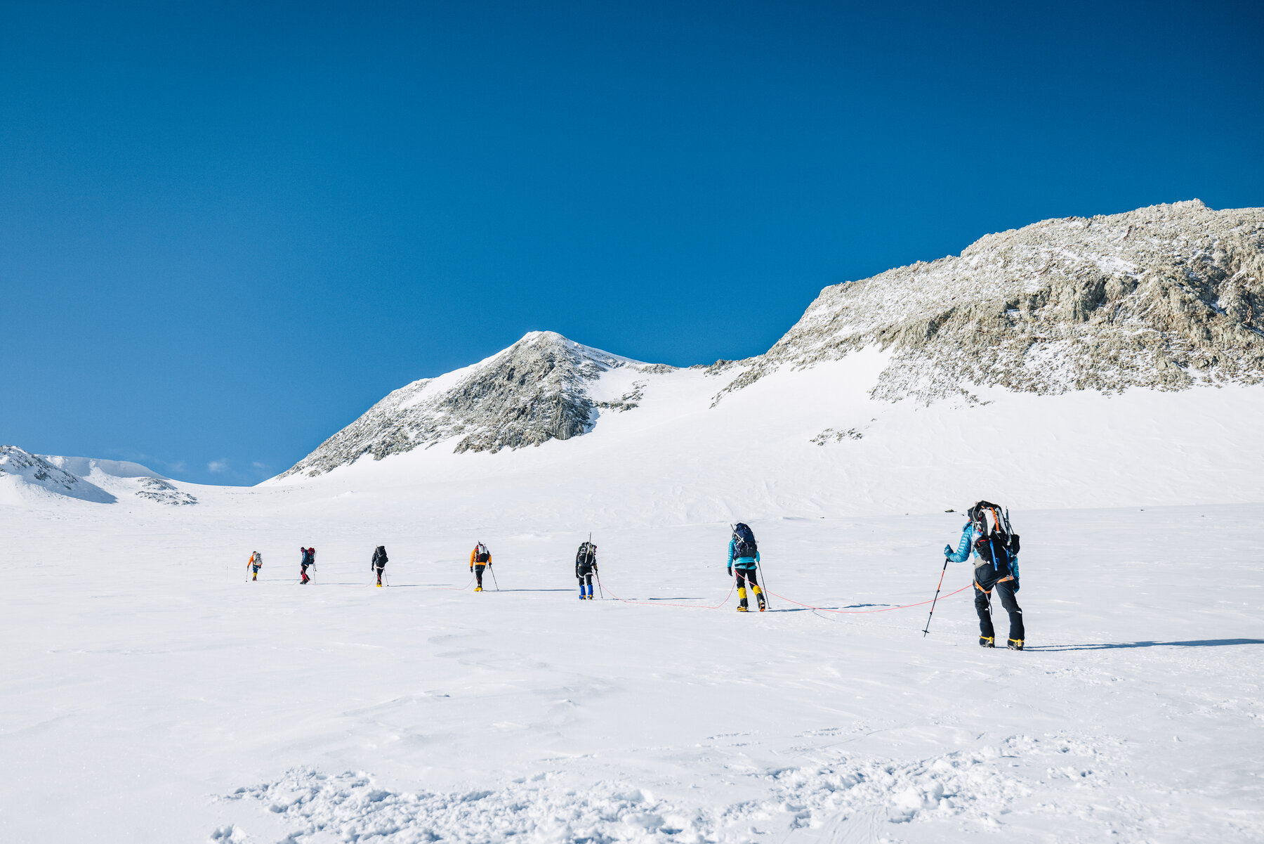 Climbers ascending the glaciated valley toward Vinson summit